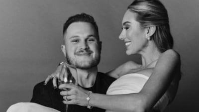 Zach Bryan is seen smiling as he lifts Samantha Leonard in his arms. (Photo Credit: Instagram)