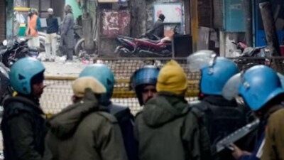 Police and security personnel stand guard near the Syed Faiz Elahi mosque after the demolition of alleged encroachments from a land adjoining the mosque. (PTI)