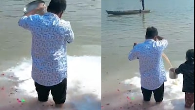 The devotee adjusts his position so the milk does not fall into their containers.(Photo Credit : X)