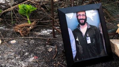 A photograph of 37-year-old Alex Pretti can be seen at a makeshift memorial in the area where he was shot dead by federal immigration agents. (AFP)