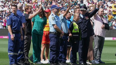 First responders and survivors from the Bondi Beach shooting wave from the field during a ceremony ahead play on day one of the fifth and final Ashes Test (Picture credit: AP)