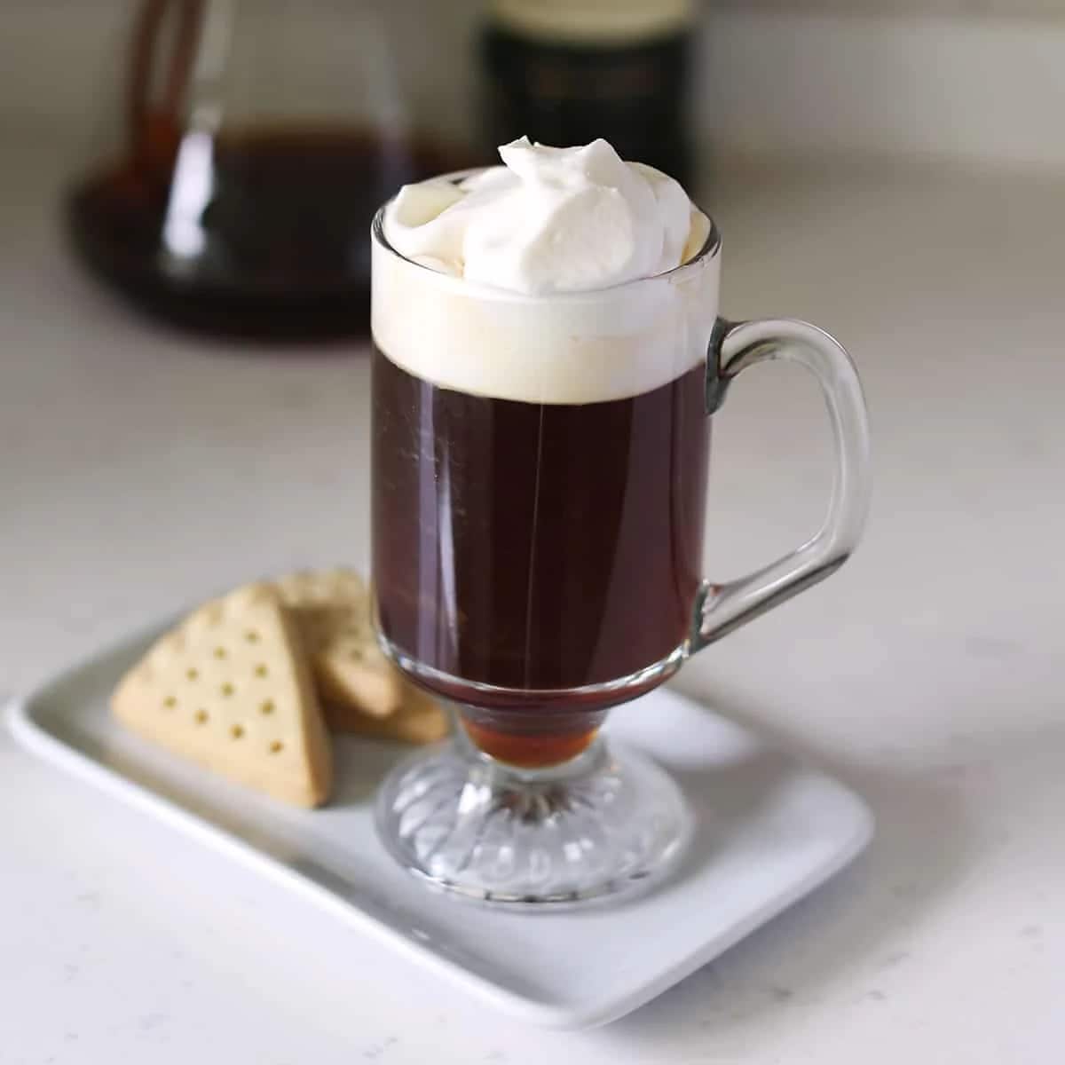 The Irish Americano mixes hot coffee with Irish whiskey, sugar and a layer of cream and it was invented in the 1940s to warm up shivering travellers. The non-alcoholic version, sometimes called a temperance Irish coffee or mocktail-style Irish coffee, skips the whiskey but keeps the comfort intact. It usually starts with an Americano base, then you add some sugar, spices and cream for that familiar feel. Basically, it is like a warm hug in a cup. The Irish Americano mixes hot coffee with Irish whiskey, sugar and a layer of cream and it was invented in the 1940s to warm up shivering travellers. The non-alcoholic version, sometimes called a temperance Irish coffee or mocktail-style Irish coffee, skips the whiskey but keeps the comfort intact. It usually starts with an Americano base, then you add some sugar, spices and cream for that familiar feel. Basically, it is like a warm hug in a cup.