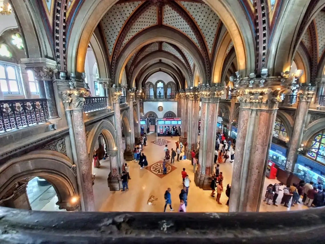 Chhatrapati Shivaji Maharaj Terminus feels more like a palace than a station. The stone dome, carved gargoyles, and tall arches show perfect balance between British design and Indian art. Every corner reflects careful planning and skilled workmanship. Despite its age, the station continues to serve millions daily without losing its charm. Tourists from across the world visit just to admire its design. It stands as a reminder of how history and daily life can exist together.