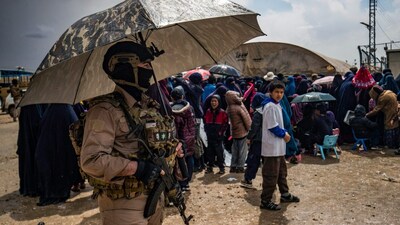Members of Syria's Kurdish Internal Security Police Force and the Kurdish-led Syrian Democratic Forces (SDF) stand guard during a joint security operation at Camp Roj. (AFP file photo)