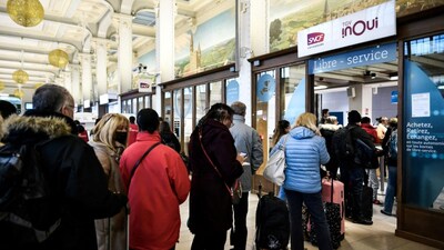 Commuters wait in line to buy tickets at the TGV Inoui shop at Gare de Lyon in Paris. (AFP file photo)