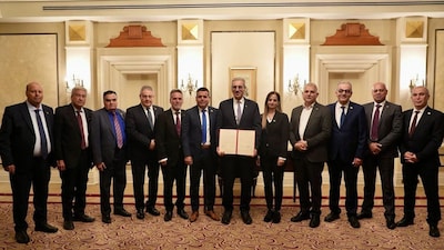 Ali Shaath (C), head of the new Palestinian technocratic committee for administering the Gaza Strip, posing with its members in Cairo on January 18.