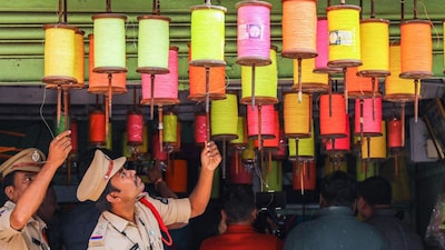 Hyderabad: Police personnel inspect colourful threads to check the sale of Chinese kite strings ahead of the 'Makar Sankranti' festival, in Hyderabad, on Tuesday. (PTI)