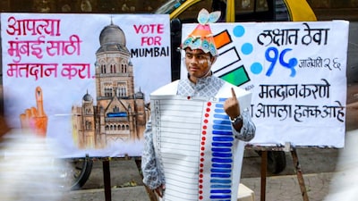 BMC elections 2026: A student wears an Electronic Voting Machine (EVM)-themed costume made of paper as part of a voter awareness campaign, in Mumbai on Saturday. (PTI)