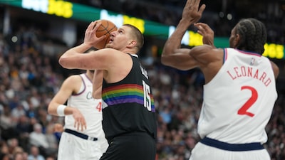 Denver Nuggets center Nikola Jokić (15) goes up for a basket as Los Angeles Clippers forward Kawhi Leonard (2) defends in the first half of an NBA basketball game Friday, Jan. 30, 2026, in Denver. (AP Photo/David Zalubowski)