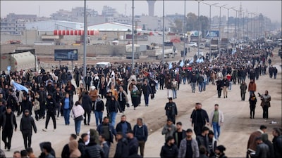 People wait for Kurdish fighters who withdrew from Aleppo, which fell under the control of the Syrian government. (Reuters)