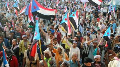 Supporters of the UAE-backed separatist Southern Transitional Council (STC) wave flags of the group in Yemen. (Reuters)