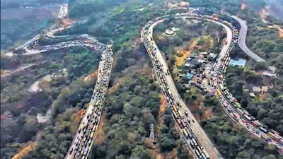 Vehicles stuck in a traffic jam on the Mumbai-Pune Expressway after a gas tanker overturned in the Khandala Ghat section in Raigad on Wednesday. (PTI)