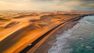 Ocean on one side, the world’s oldest desert on the other, in Namibia, cold Atlantic air meets desert heat within the same horizon. This southwestern African nation blends desert, coastline, wildlife and wetlands together where the icy blue waters sit beside towering red dunes. (Image-iStock)