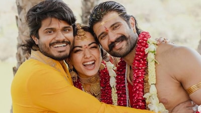 Anand Deverakonda embraces Vijay Deverakonda and Rashmika Mandanna at their wedding.