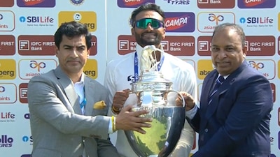 BCCI chief Mithun Manhas (L) and secretary Devajit Saikia (R) presenting the Ranji Trophy silverware to Jammu & Kashmir captain Paras Dogra