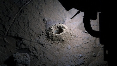 Using lights from the Mars Hand Lens Imager, Curiosity illuminated a freshly drilled hole and captured an uncommon nighttime image to help scientists examine Martian geology. (IMAGE: NASA/JPL-Caltech/MSSS)
