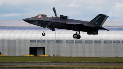 A Royal Air Force F-35 lands at the Farnborough International Air Show in Farnborough, England (File photo/AP)