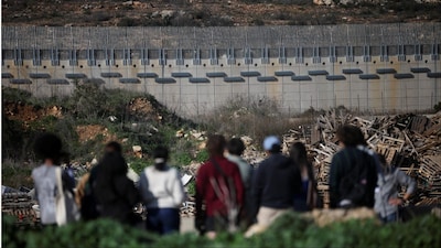 People look towards Lebanon from the Israeli side of the Israel-Lebanon border (Photo: Reuters)