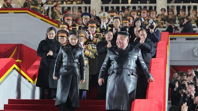 North Korean leader Kim Jong Un (front R) and his daughter Kim Ju Ae (front L) attending the military parade. (AFP)