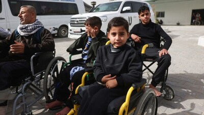 Young Palestinian patients sitting in wheelchairs wait in the grounds of the Red Crescent Hospital to be evacuated from the Gaza Strip via the Rafah border crossing with Egypt. (AFP photo)