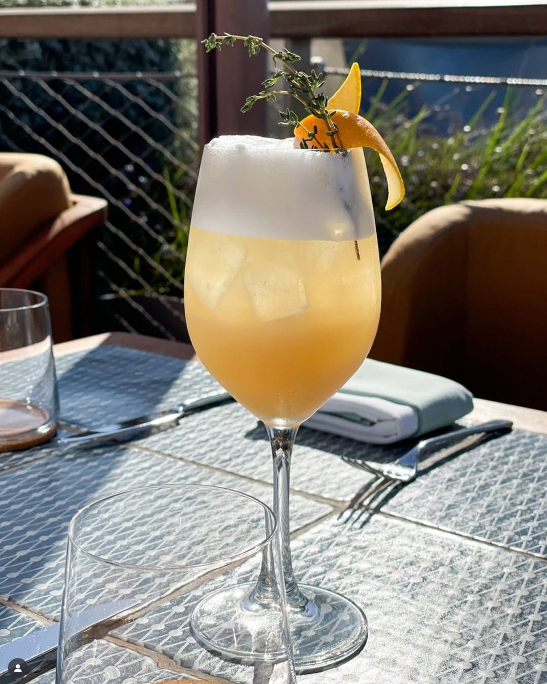 Presentation:- Glassware: Champagne flute, chosen for its tall, slender shape that preserves bubbles and enhances the visual appeal. - Garnish: A simple orange wedge perched on the rim, adding a pop of color and reinforcing the citrus notes.