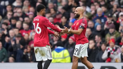 Manchester United's Amad Diallo, left, and Bryan Mbeumo react after a goal during the English Premier League soccer match between Manchester United and Tottenham in Manchester, England, Saturday, Feb. 7, 2026. (AP Photo/Jon Super)