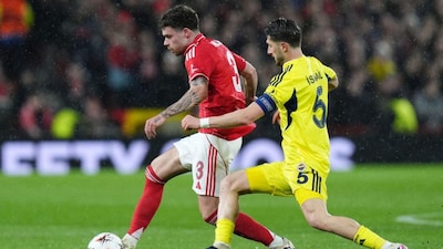Nottingham Forest's Neco Williams, left, and Fenerbahce's Ismail Yuksek in action during the Europa League knockout phase play-off second leg match between Nottingham Forest and Fenerbahce in Nottingham, England, Thursday Feb. 26, 2026. (Jacob King/PA via AP)