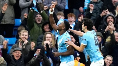 Manchester City's Marc Guehi, left, celebrates scoring during the English FA Cup fourth round soccer match between Manchester City and Salford City in Manchester, England, Saturday Feb. 14, 2026. (Nick Potts/PA via AP)
