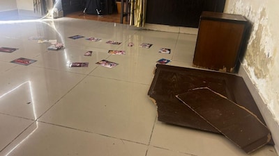 Photos were found scattered inside around the room in which the sisters lived in a residential building at Ghaziabad's Loni area. (Image: News18)