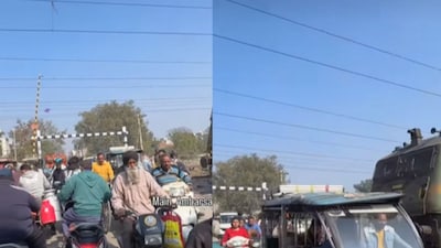Clip shows a train halted on the tracks as traffic moves. (Photo Credit: Instagram/main_ambarsariya)