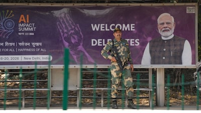 A BSF jawan stands guard at a bus stop, ahead of the AI Impact Summit 2026, in New Delhi on February 15, 2026. (Image: PTI)