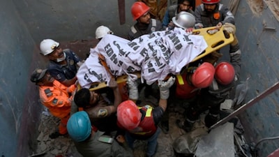 Rescue workers recover a victim’s body amid the debris of a collapsed building following an explosion, in Karachi on Thursday. (AFP)
