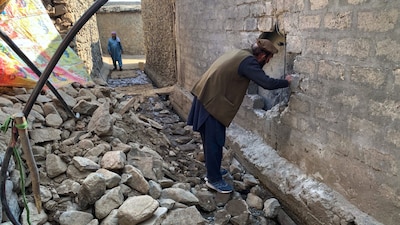 Villagers examine damages due to overnight cross border fighting between Pakistan and Afghan forces, at a village in Bajaur. (Image: AP)