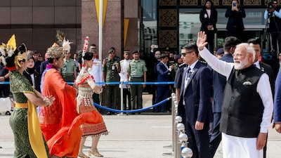 Prime Minister Narendra Modi, right, waves to the gathering before his departure, in Malaysia. (Image: PTI)
