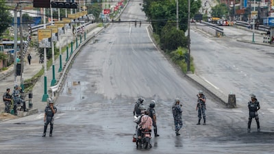 Armed Police Force (APF) personnel stand guard as security heightens amid curfew. (PTI file photo)