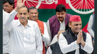 SP President Akhilesh Yadav welcomes former Congress leader Nasimuddin Siddiqui during his formal induction at the SP headquarters, in Lucknow, on Sunday. (PTI)