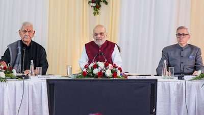 Union Home Minister Amit Shah (Centre) with Jammu and Kashmir LG Manoj Sinha (extreme left) and Chief Minister Omar Abdullah during a review meeting on development works, in Jammu and Kashmir. (@AmitShah/X via PTI)