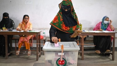 A woman casts her vote at a polling station during Bangladesh's national parliamentary election, in Dhaka, on Thursday. (AP)