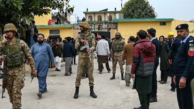 Security personnel stand guard outside a mosque following an explosion, in Islamabad on February 6. (AFP photo)