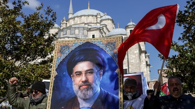 Demonstrators hold a poster of Iran's new Supreme Leader Mojtaba Khamenei inIstanbul, Turkey. (Image: Reuters)