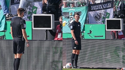 A Bundesliga 2 referee  looks puzzled as the VAR was unplugged by fans (X)