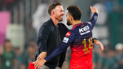Royal Challengers Bengaluru's Virat Kohli celebrates with former cricketer AB de Villiers  after winning the IPL (PTI)