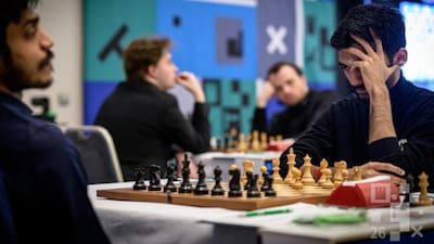 Aravindh Chithambaram (left) played a strong game and defeated world champion Gukesh Dommaraju (right); in the background: Vincent Keymer and Hans Niemann. | Photo: Petr Vrabec / Prague Chess Festival