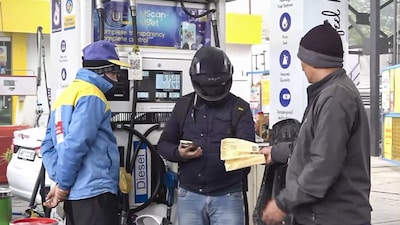 A petrol pump staff checks documents of a commuter at a gas station at Mathura Road, in New Delhi. (IMAGE: PTI)