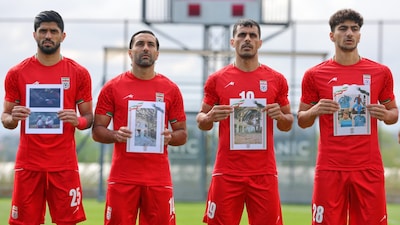 Iran's players sing national anthem holding pictures of children allegedly killed in a U.S. and Israel strikes in Iran, before a friendly match against Costa Rica in Turkey (AP Photo)