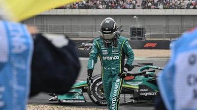 A race official waves the yellow flag as Aston Martin's Canadian driver Lance Stroll (C) leaves the track during the Chinese Grand Prix (AFP Photo)