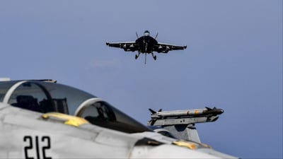 A F18 Hornet fighter jet prepares to land on the deck of the US navy aircraft carrier  (Photo: AFP)