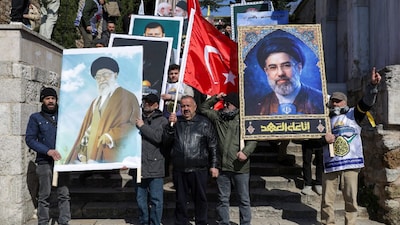 Demonstrators march as they carry posters of Iran's late Supreme Leader Ayatollah Ali Khamenei and his son, Iran's new Supreme Leader Mojtaba Khamenei, during a rally to mark al-Quds Day, amid the US-Israeli conflict with Iran, after Friday prayers in Istanbul. (IMAGE: REUTERS) 