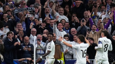 Real Madrid's Vinicius Junior celebrates after scoring with fans in the background (AP)