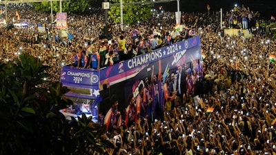 Crowds surround a double-decker bus as the India cricket team takes part in a parade celebrating their 2024 T20 World Cup win (PTI)